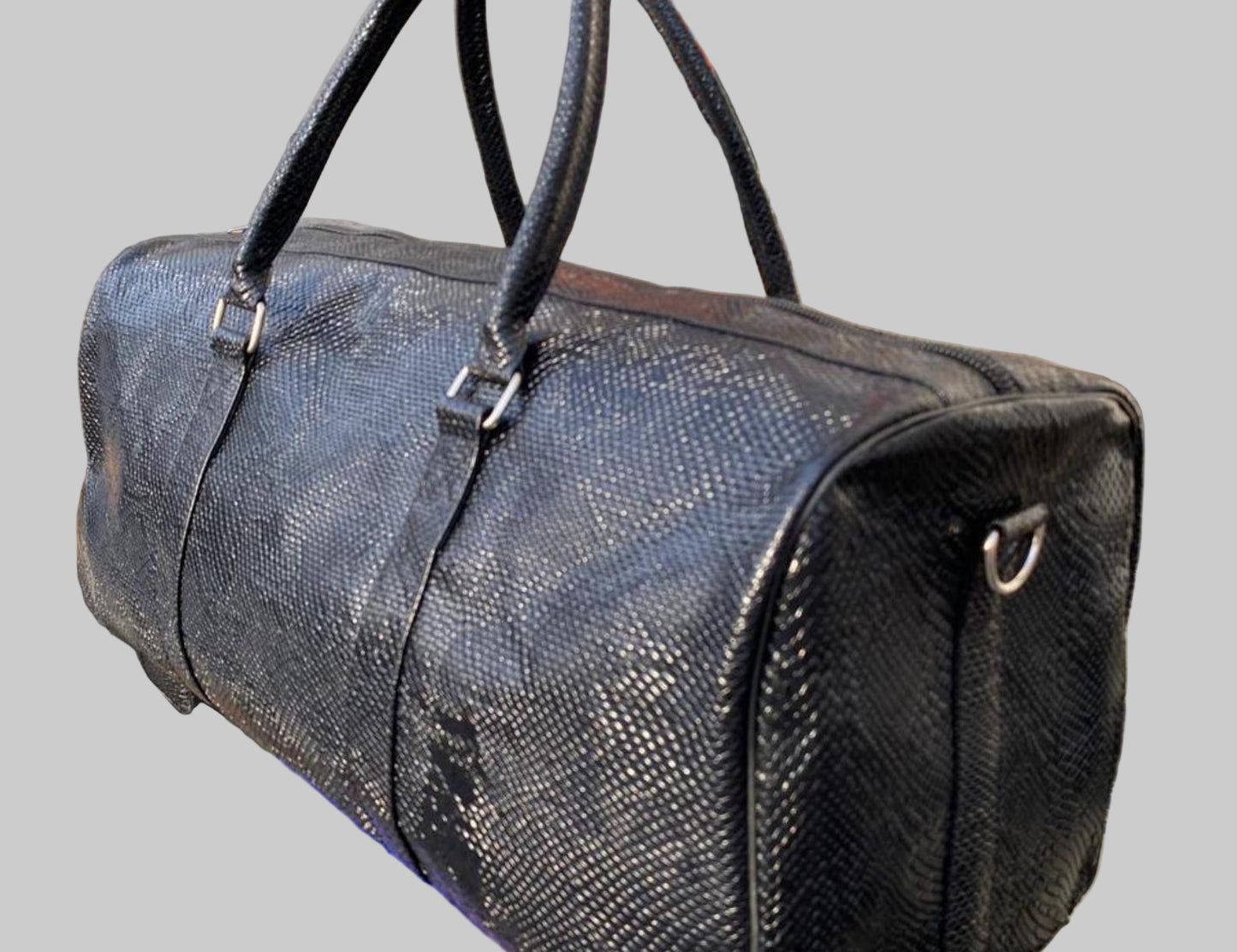 Black textured duffel bag in front of a store entrance