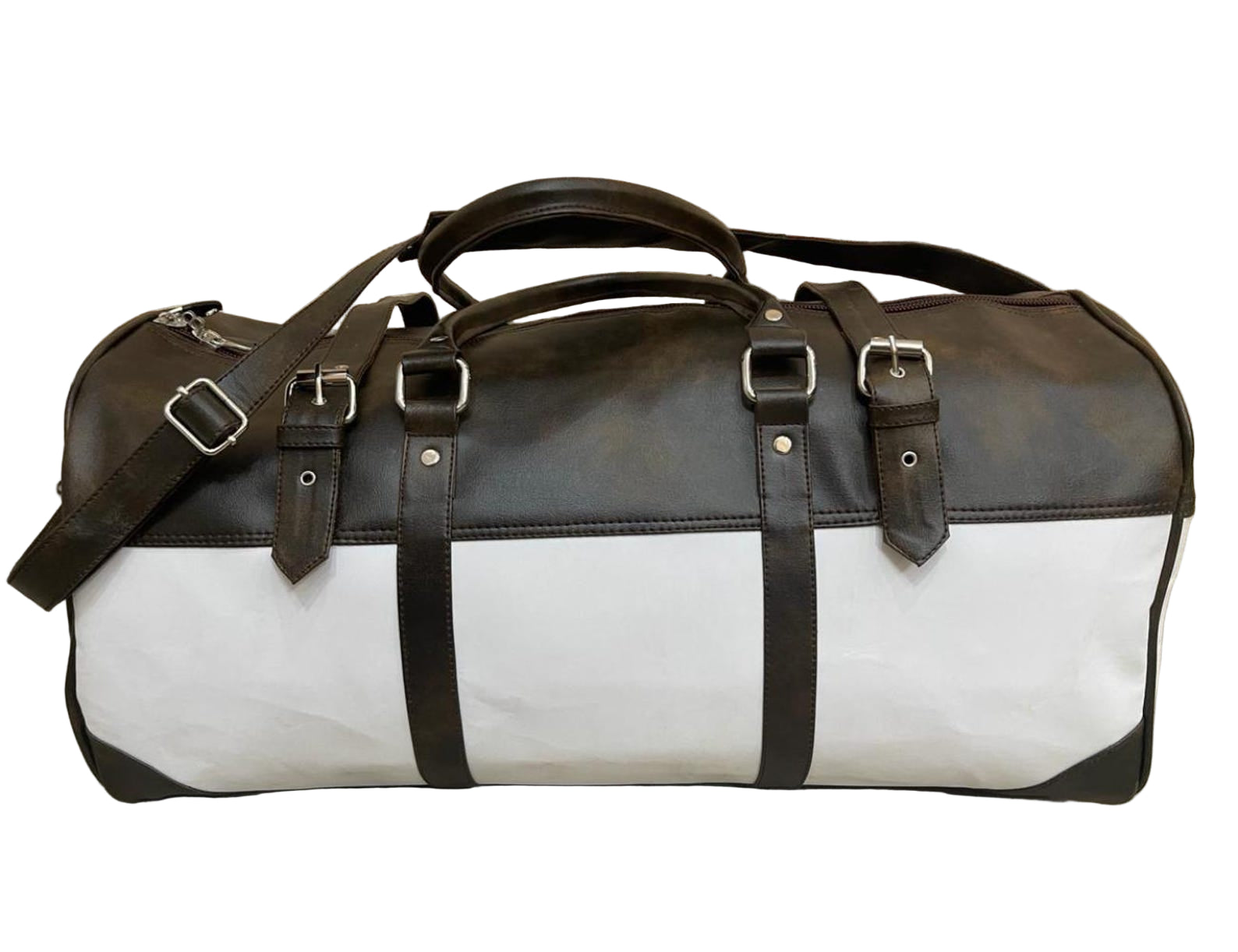 Brown and white duffel bag with black straps on a wooden floor.