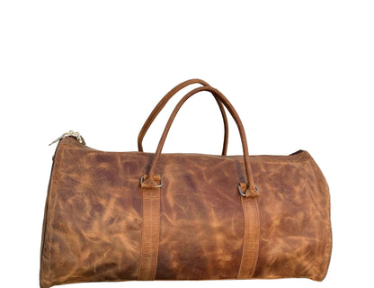 Brown leather duffel bag on a stone pavement